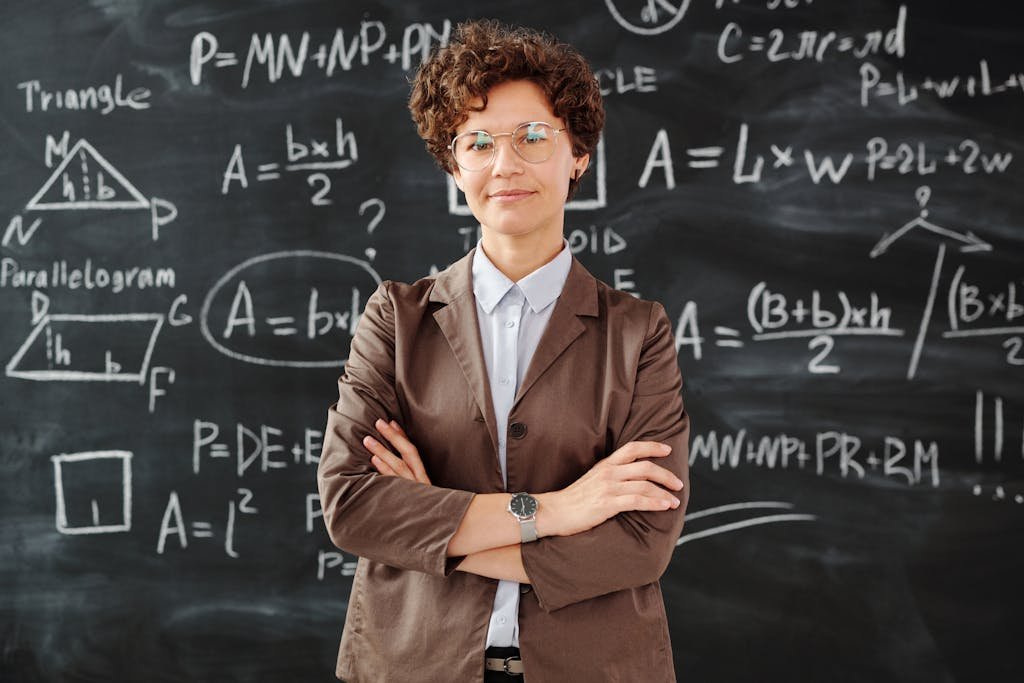 Photo by Max Fischer Photo Of Woman Standing In Front Of Blackboard